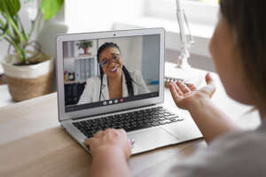 woman having video call home laptop device